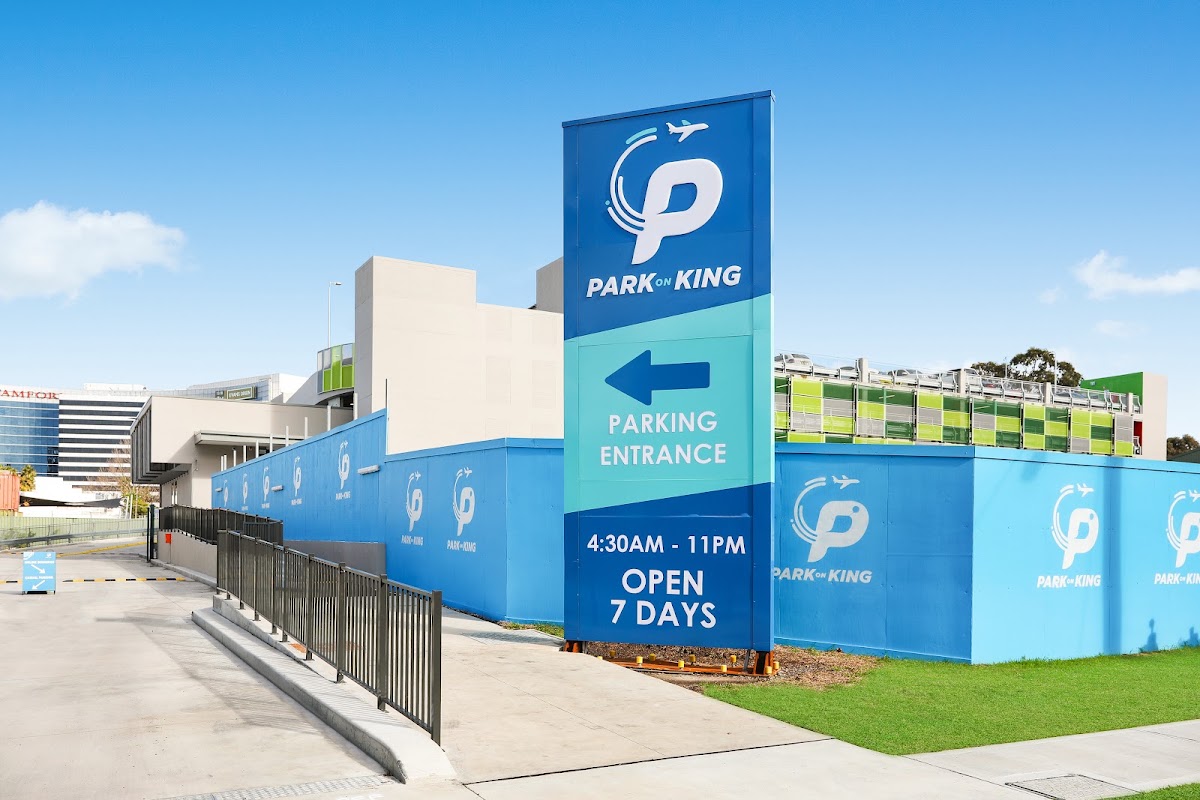 Park on King sign and entrance driveway beside the parking building